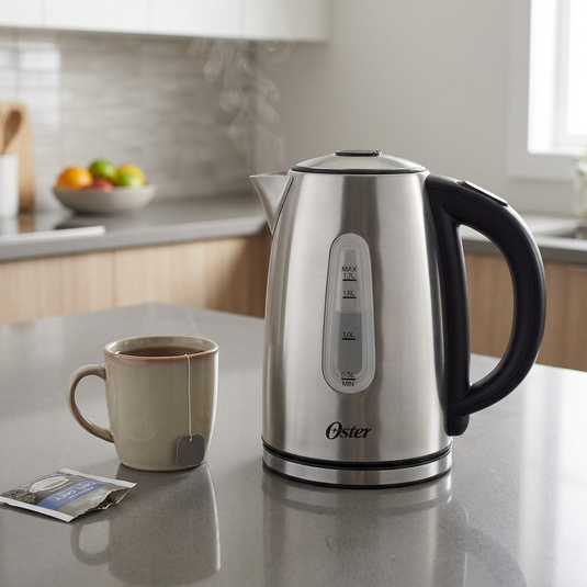 Lifestyle photograph of the exact Oster stainless steel variable temp kettle on a clean kitchen counter. A warm mug and a sachet of tea are next to it. Natural light, clean and modern.