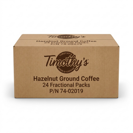 A high-resolution, centered view of the brown Timothy's Hazelnut Ground Coffee shipping box, featuring dark brown logo and text, against a pure white background.