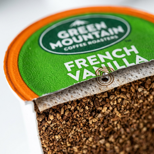 Extreme close-up of a K-Cup's multi-layered filter and the texture of its French Vanilla coffee grounds.