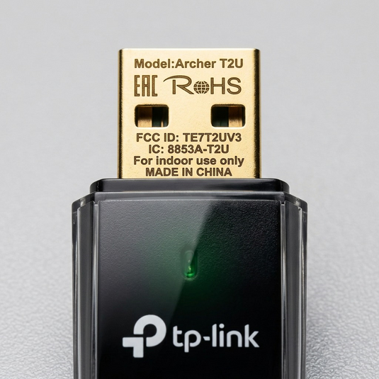 Macro view of deep-engraved details on the Archer T2U's gold USB connector and textured casing.